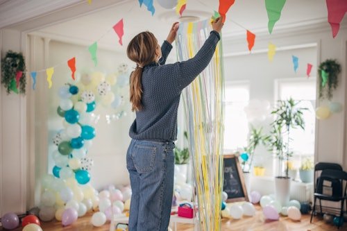 young-woman-decorating-room I Hate Throwing My Kids' Birthday Parties
