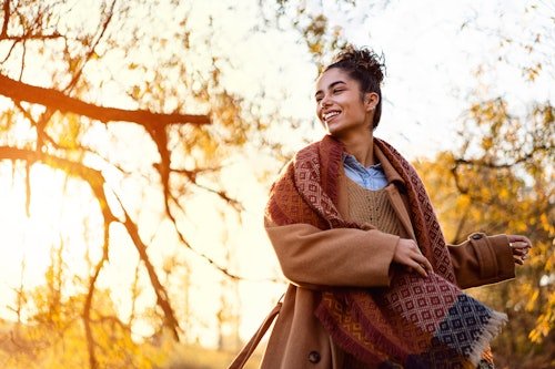 beautiful-young-woman-enjoying Which Fall Fashion Staple You *Need,* According To Your Zodiac Sign