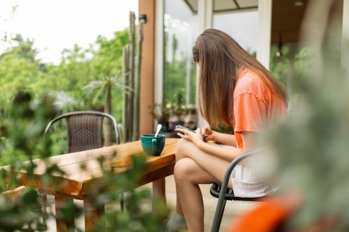 teenage-girl-sitting-on I'm In My Potted Plant Parenting Era & It Sure Feels Weird
