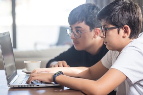 two-boys-working-together Parents Sue Their Son's School After He Was Disciplined For Using AI