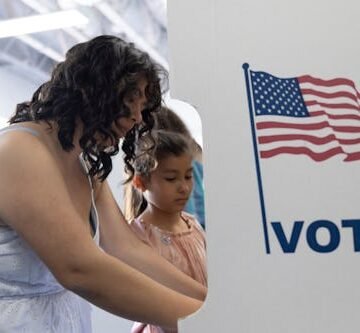 gettyimages-1401422610 Election Day FAQ: Can You Bring Your Kids With You To Vote? An Expert Answers