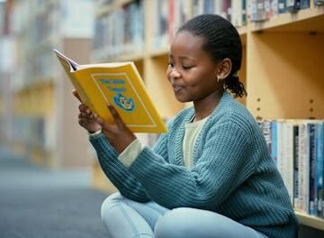 girl-reading-library-with Texas Bill Increases Scrutiny On School Libraries & Kids' Reading