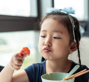 gettyimages-1310753283 A Study Found That Kids Who Eat Seafood Are Kinder & Friendlier