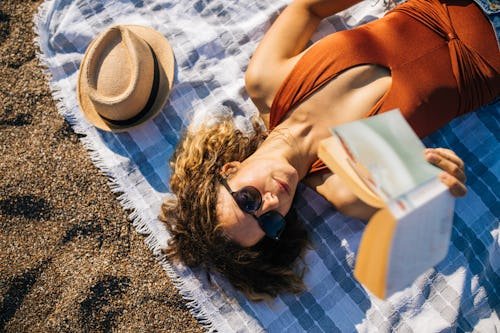 woman-lies-on-the The 15 Most Anticipated Books Of The Summer, According To Goodreads