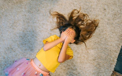 young-girl-lies-on AAP Pushes Back On HHS Guidelines for Pediatric Gender Dysphoria