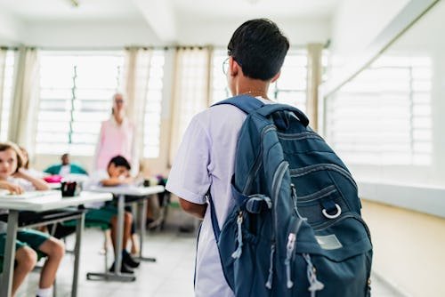student-carrying-backpack-arriving Is It OK To Teach My Kid They Don't Have To Be Friends With Everyone?
